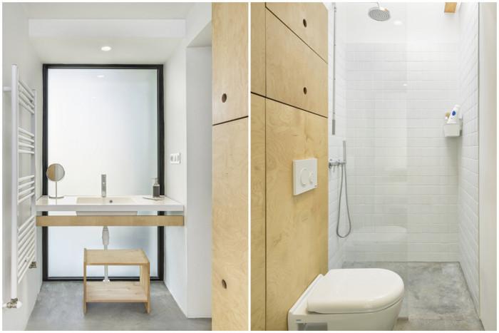 В банята доминиращото бяло е разчупено с интересни елементи от дърво